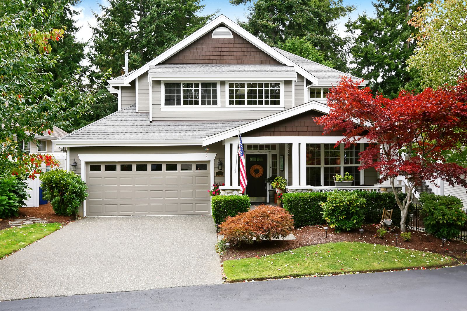 Grey-House-with-Garage-and-Driveway-and-Porch-with-American-Flag