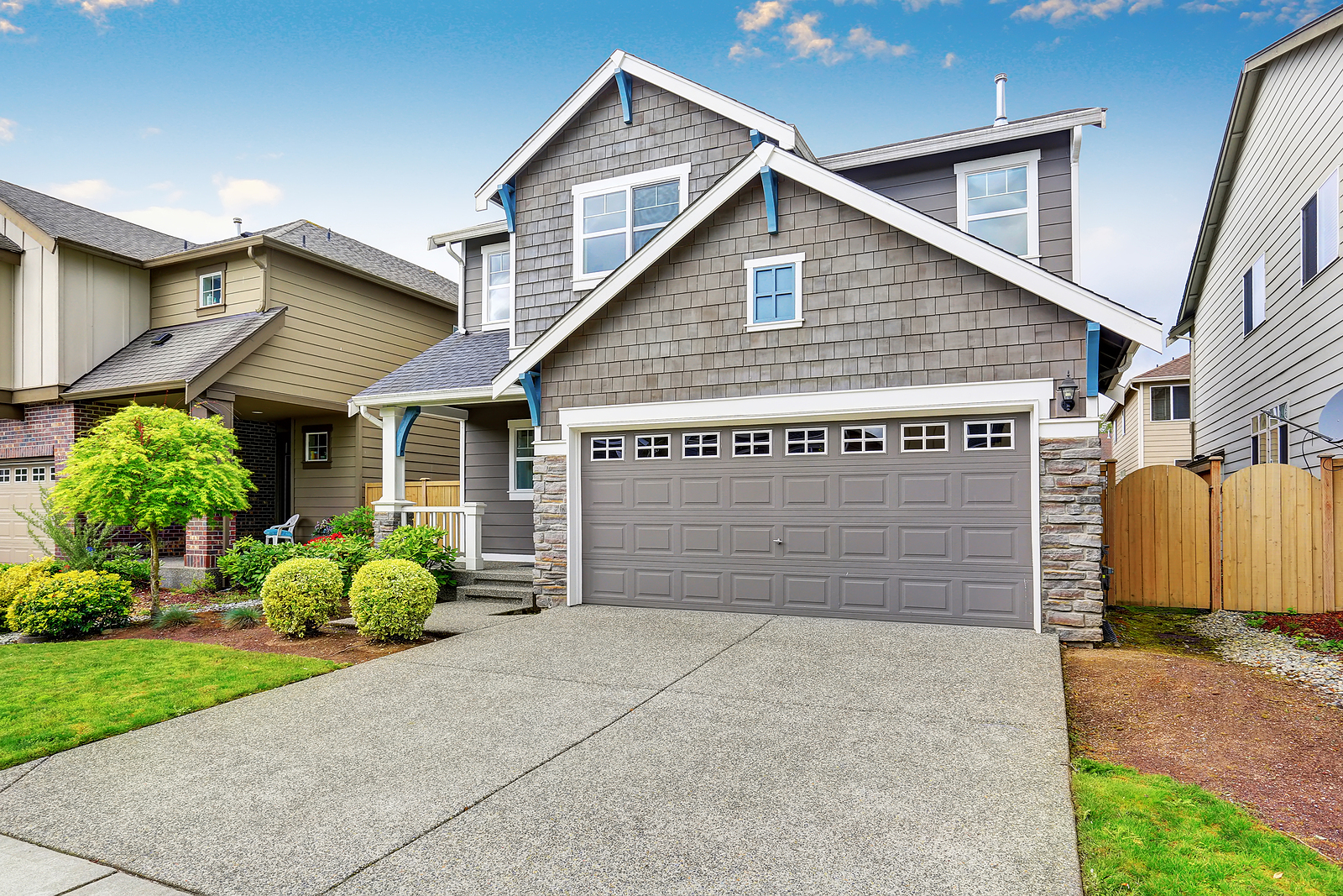 Two-Level-Grey-House-with-Grey-Garage-Door-and-Driveway